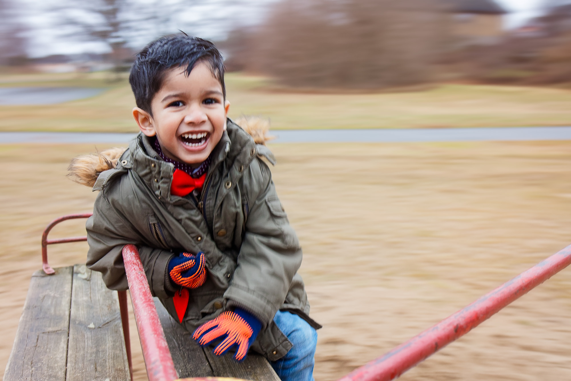 Canon EOS 80D + Canon EF 24-70mm F4L IS USM sample photo. Child in a spinning carousel at the playground. photography