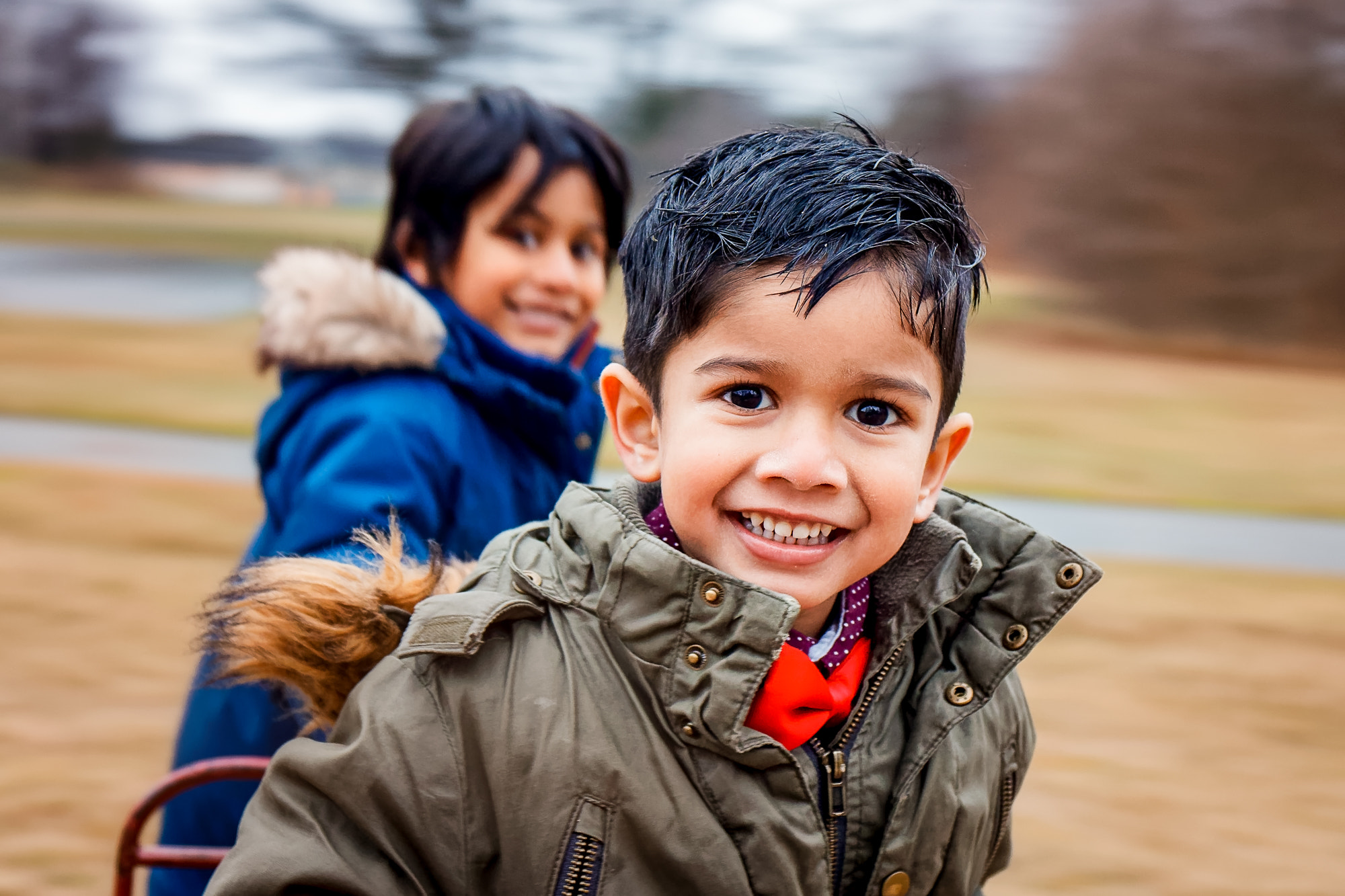 Canon EF 24-70mm F4L IS USM sample photo. Portrait of two kids spinning a carousel in karlshamn, sweden. photography