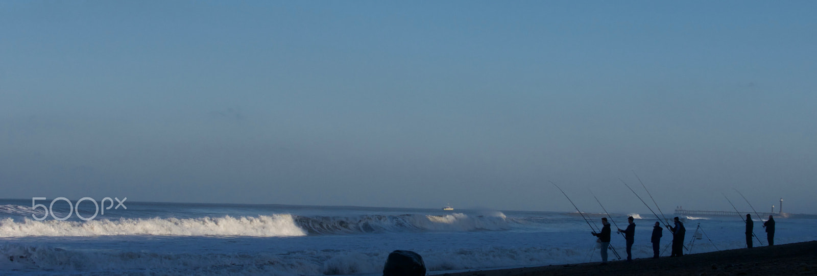 Panasonic Lumix G X Vario 35-100mm F2.8 OIS sample photo. Winter surf fishermen on beach photography