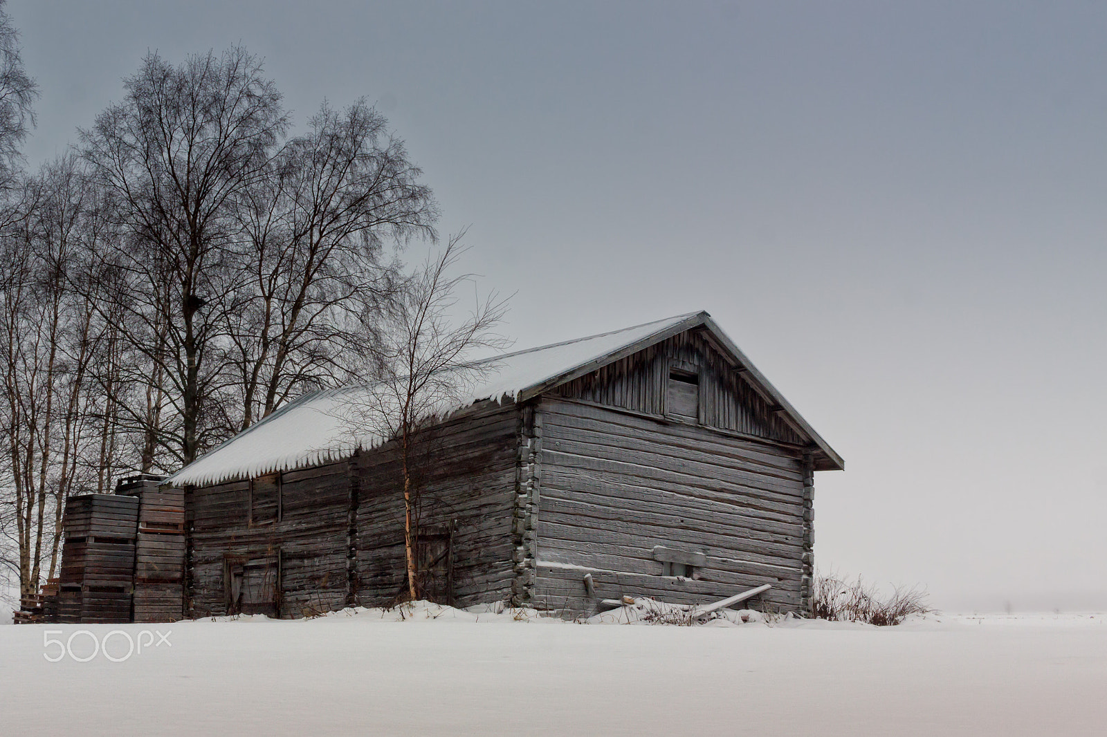 Canon EF-S 24mm F2.8 STM sample photo. Old barn and wooden crates on the fields photography