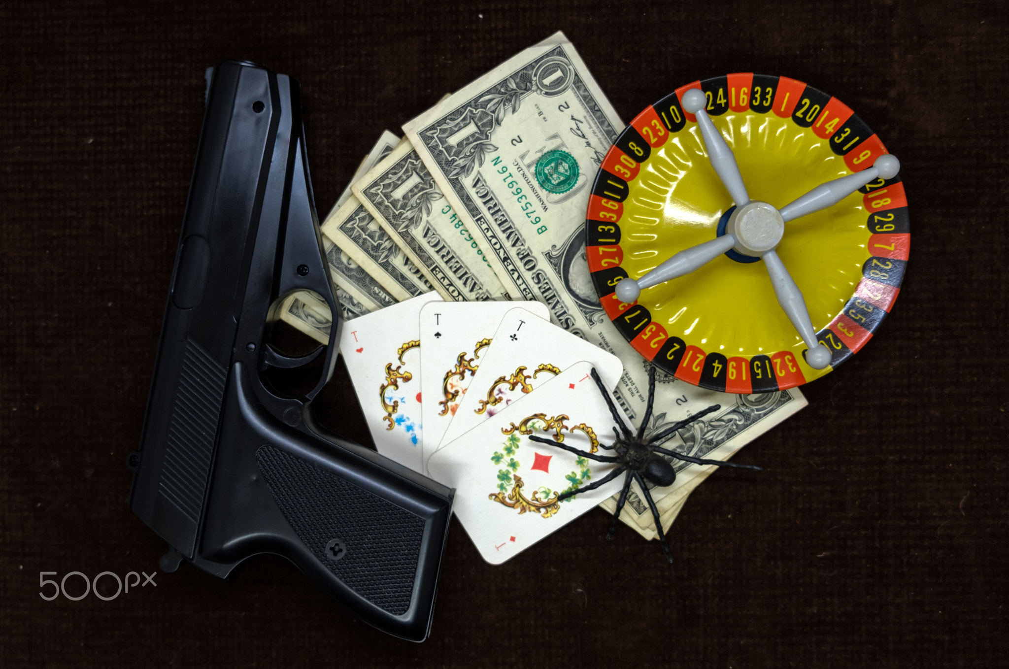 Card with money. gun and roulette