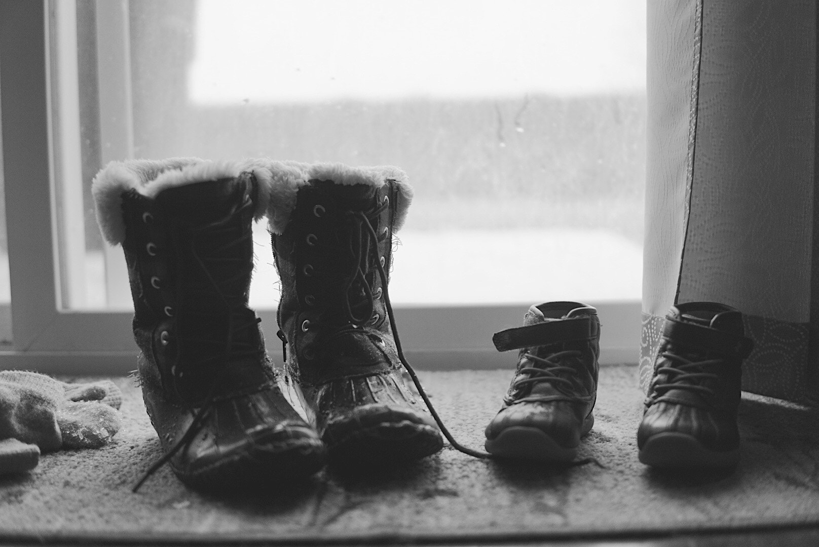 Sigma 30mm F1.4 DC DN | C sample photo. Wet boots and soaking gloves. a remnant of two kids playing in the fresh falling snow. photography