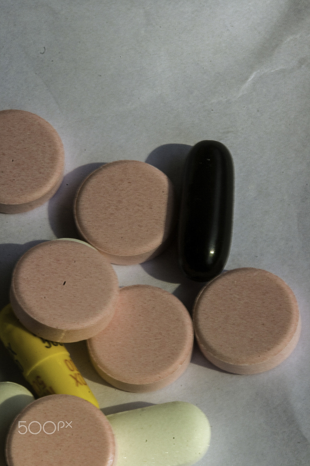 Canon EF 100mm F2.8 Macro USM sample photo. Pink, white medicines along with yellow and black capsules on a photography
