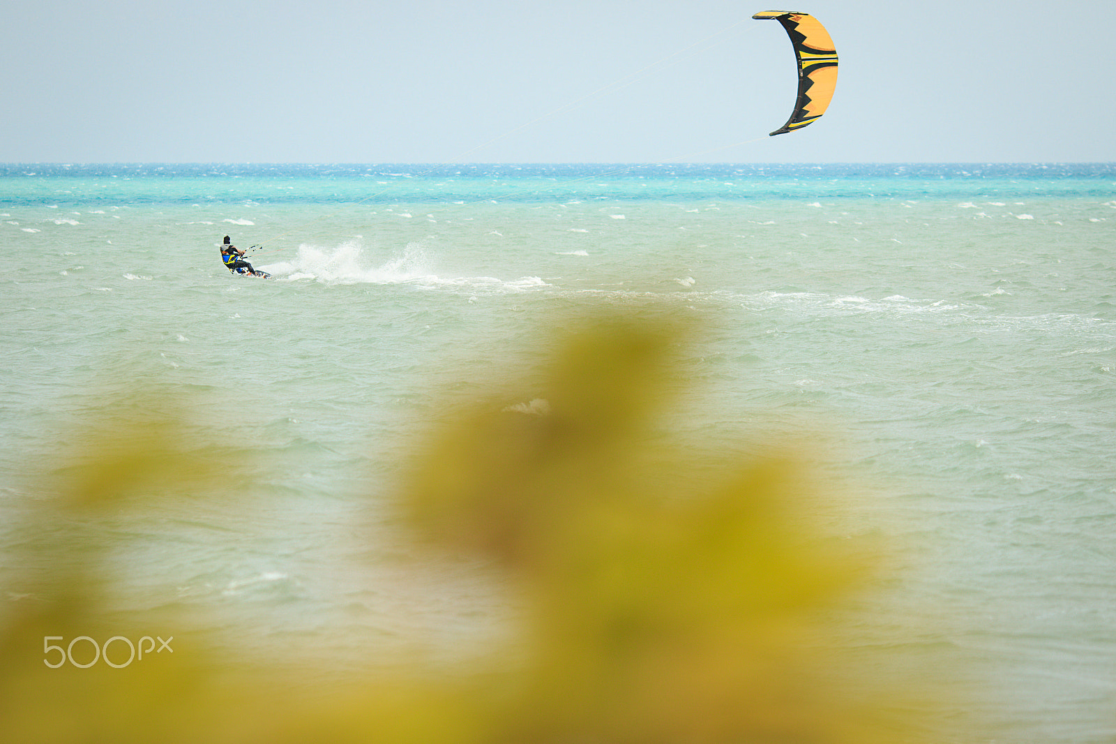 Canon EOS 7D Mark II sample photo. Kiteboarder sportsman riding far in the sea photography