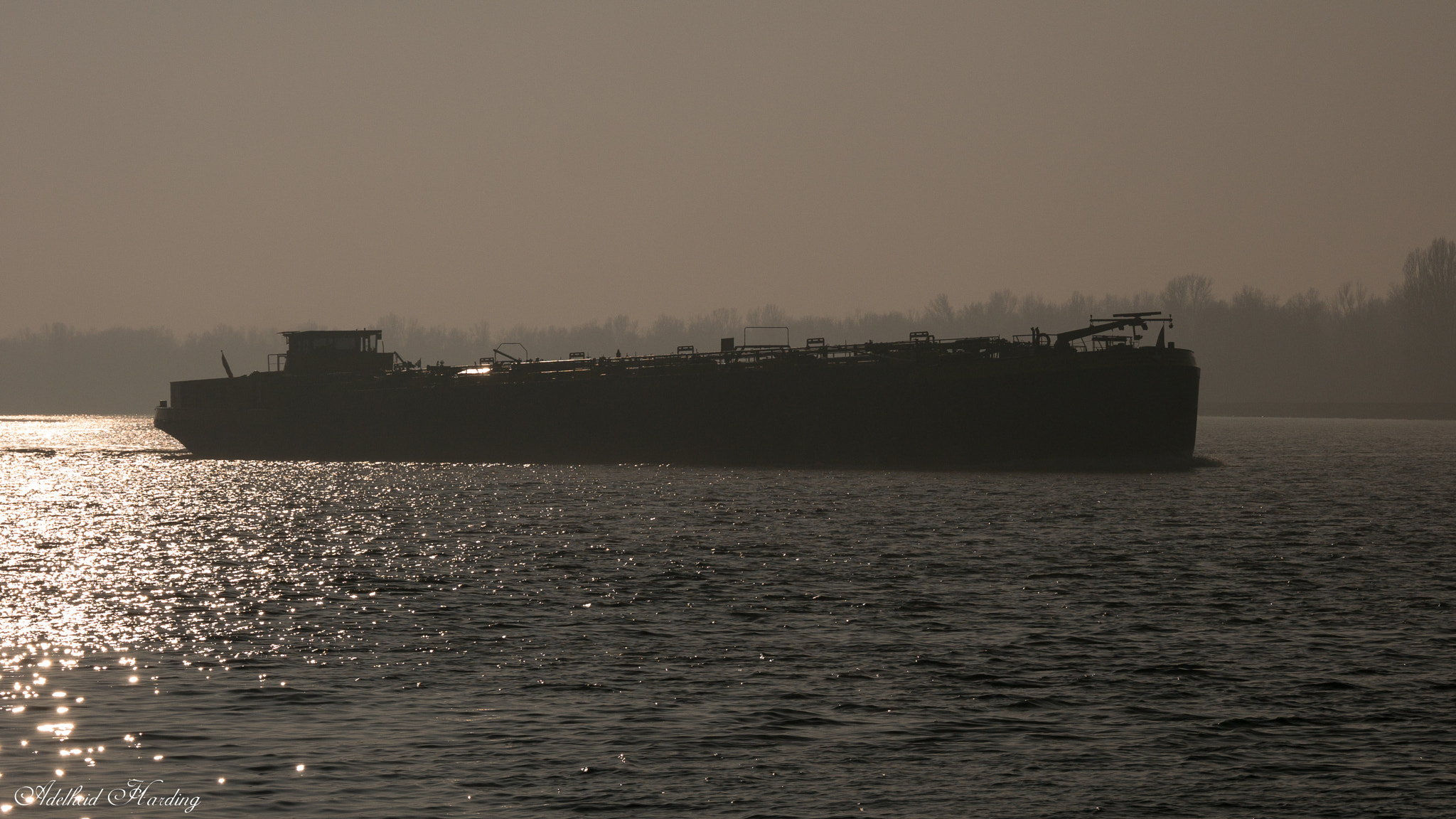 LUMIX G VARIO 35-100/F4.0-5.6 sample photo. Silhouetted barge photography