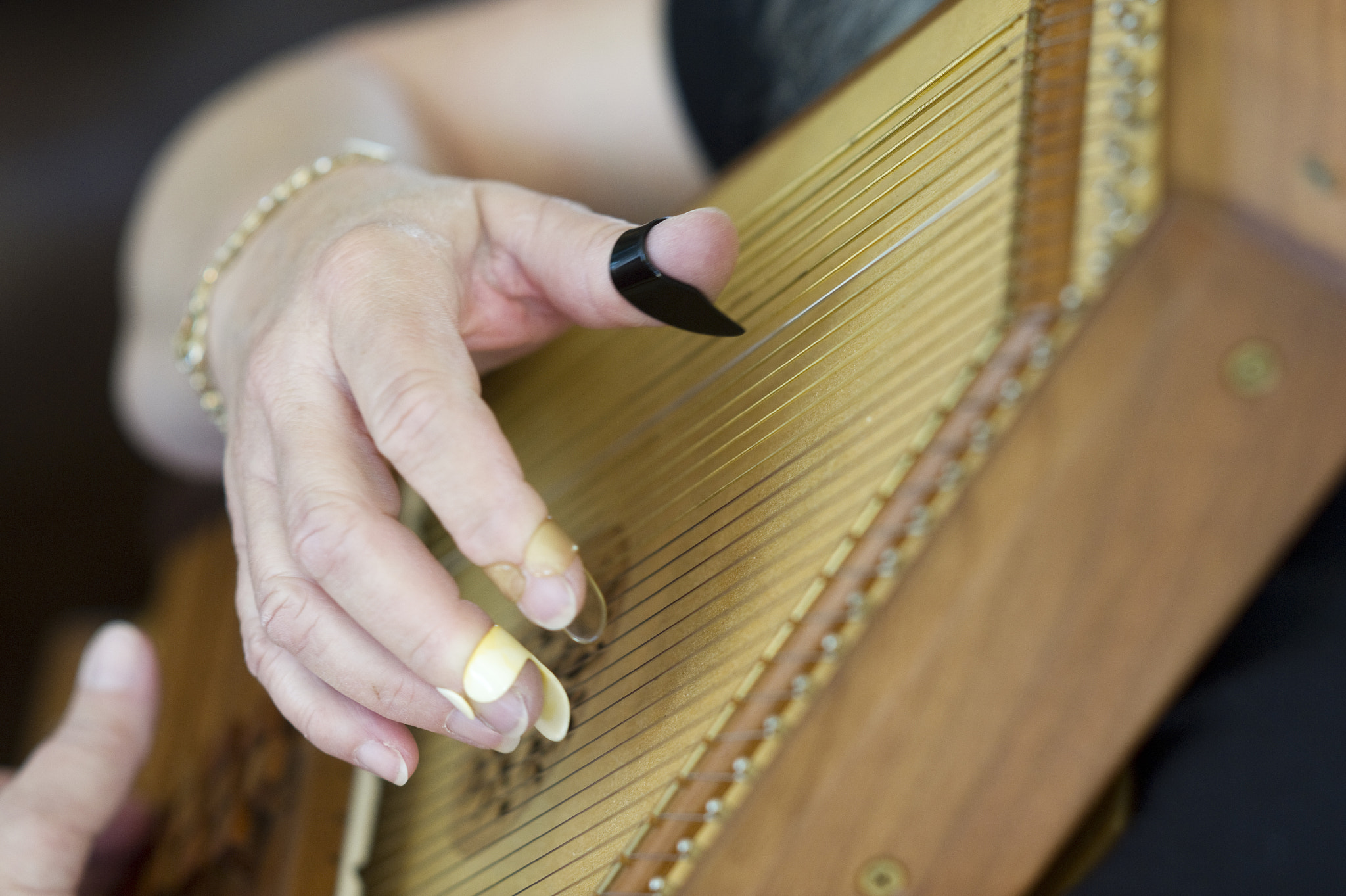 AF DC-Nikkor 135mm f/2 sample photo. Close up of hand playing autoharp photography