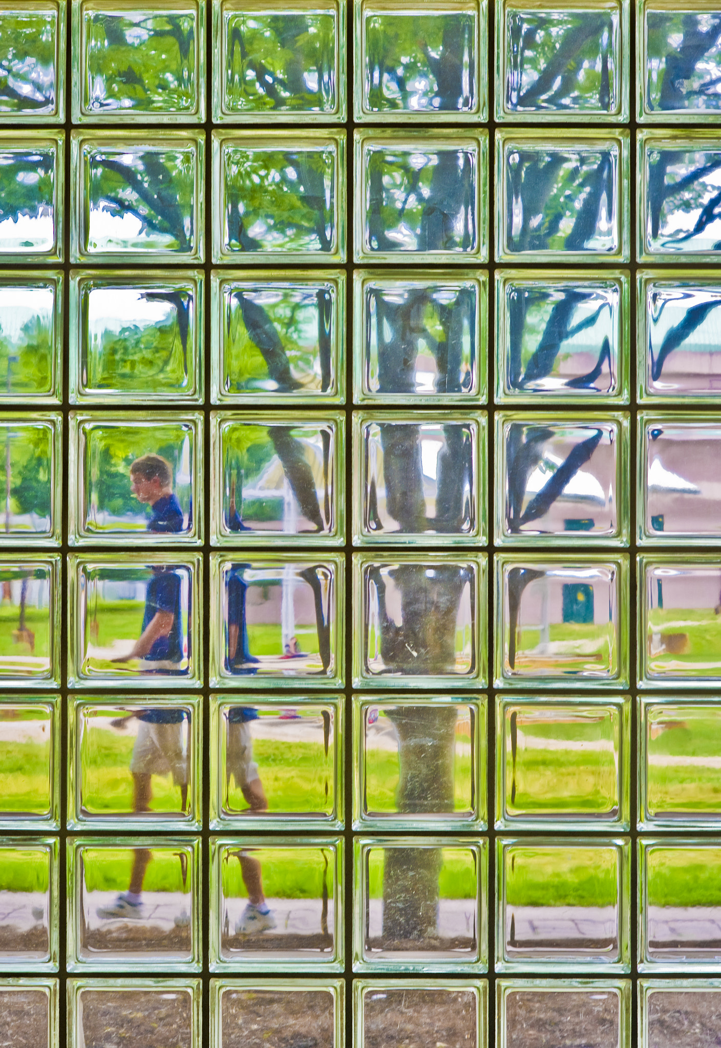 Nikon D3S + AF Nikkor 85mm f/1.8 sample photo. Person walking past glass block courtyard windows photography