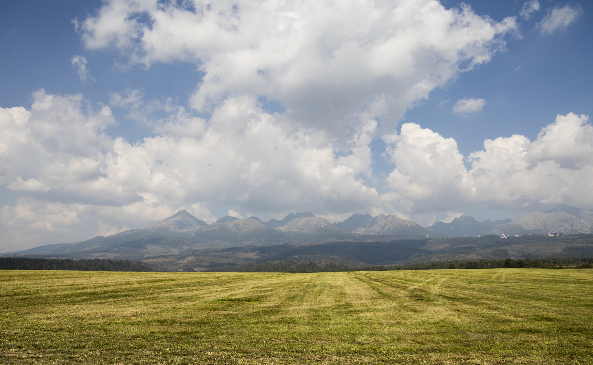 Canon EOS 5DS sample photo. Cloudscape over field and mountains photography