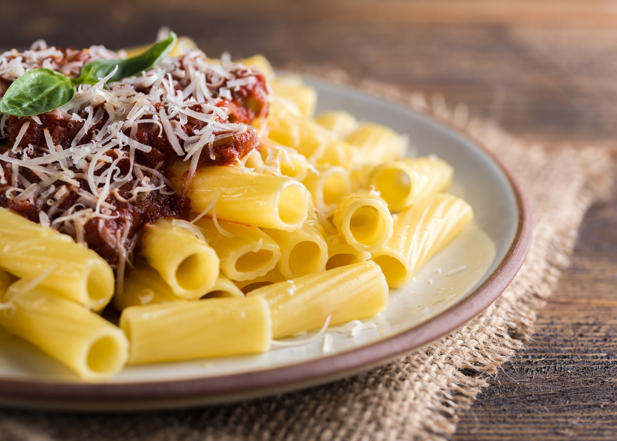 Nikon D610 + Tamron SP 90mm F2.8 Di VC USD 1:1 Macro (F004) sample photo. Pasta with tomato sauce and parmigiano on white plate on natural wooden table. photography