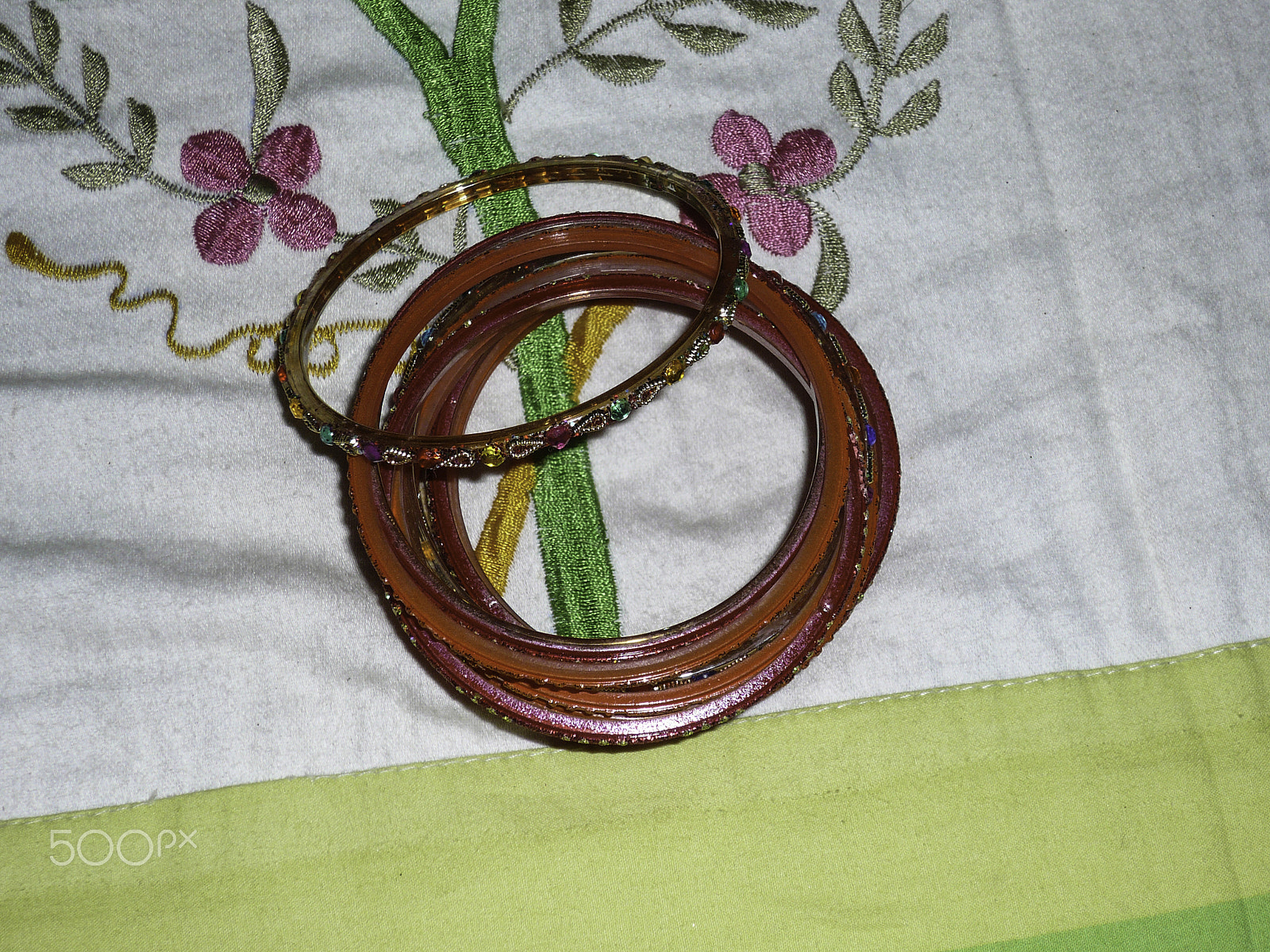 Panasonic DMC-FX100 sample photo. Hindu religious bangles on a printed bed sheet photography