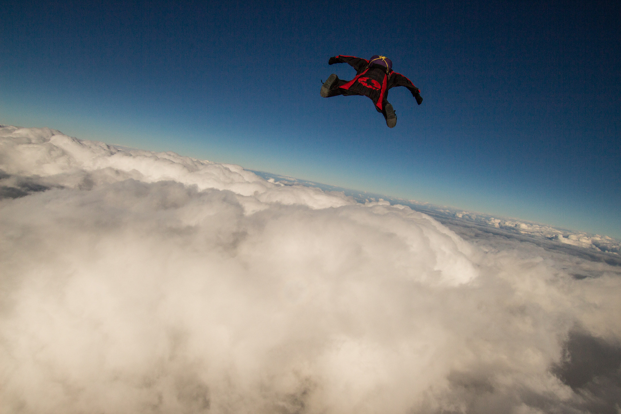 Canon EOS 700D (EOS Rebel T5i / EOS Kiss X7i) + Sigma 10-20mm F3.5 EX DC HSM sample photo. Wingsuit over clouds photography