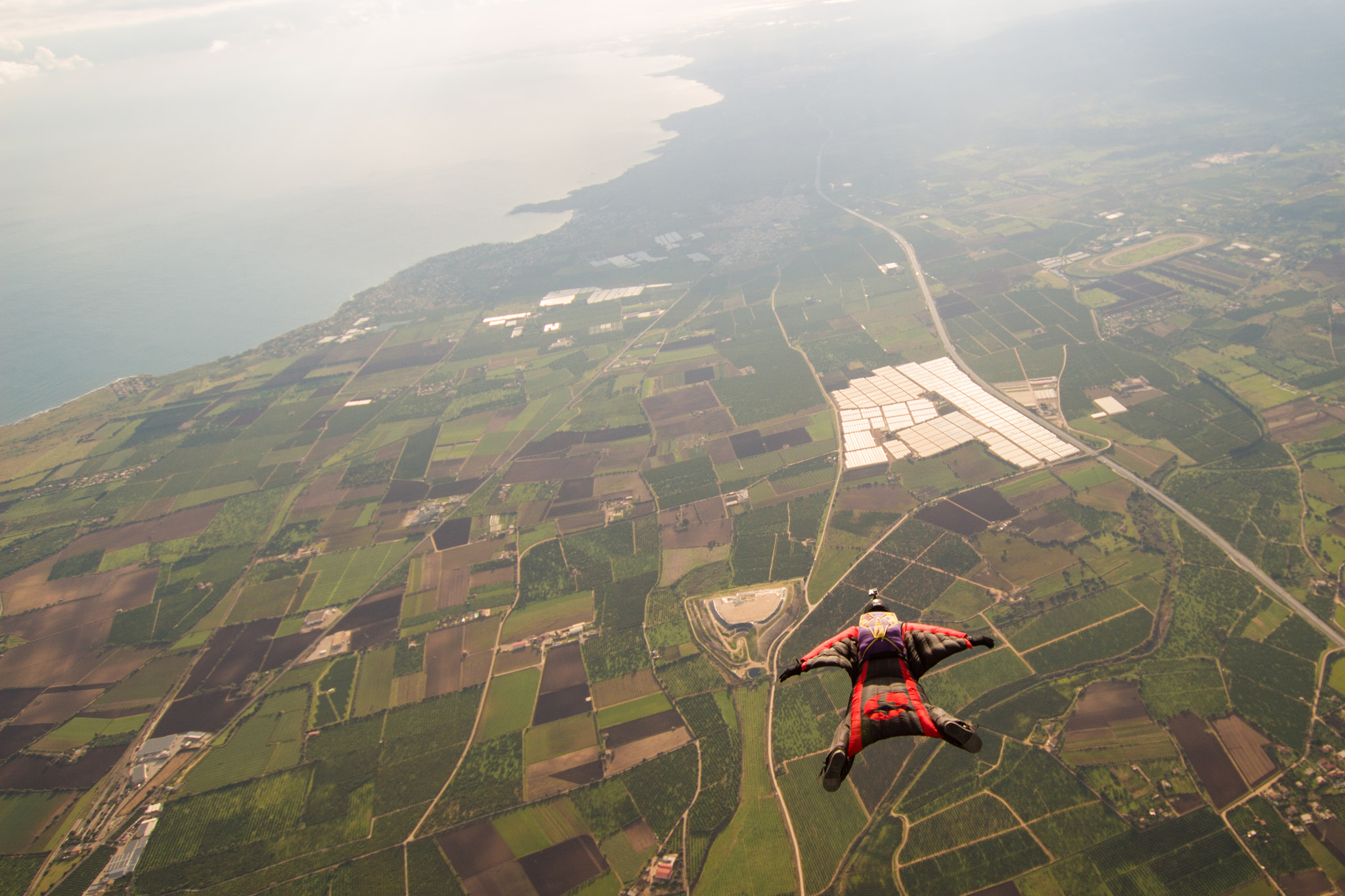 Sigma 10-20mm F3.5 EX DC HSM sample photo. Wingsuit to ocean photography