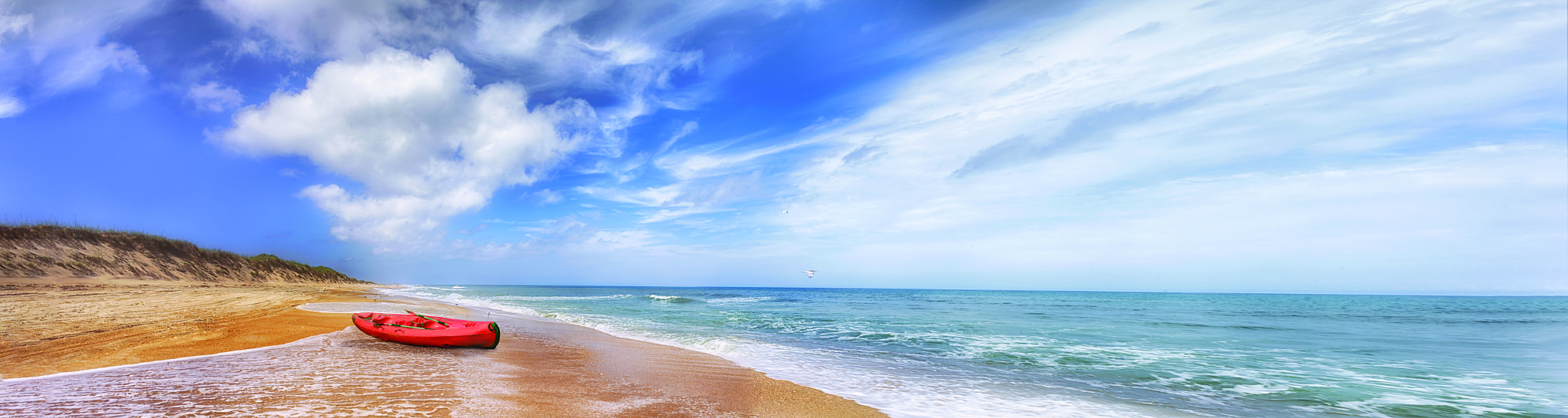 Nikon D3S + Nikon AF Nikkor 24mm F2.8D sample photo. Beach landscape of outer banks with red kayak photography