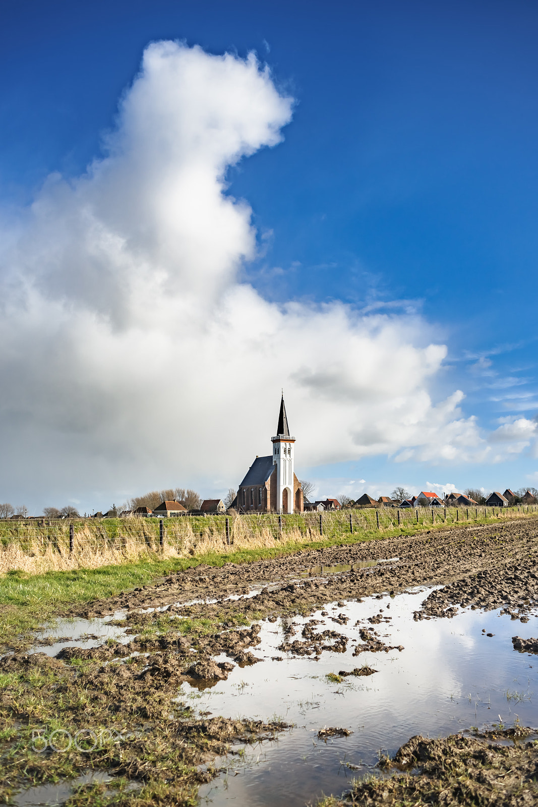 Sony 28mm F2.8 sample photo. Old dutch church. farmland. stormy cloudy sky. texel. den hoorn. photography