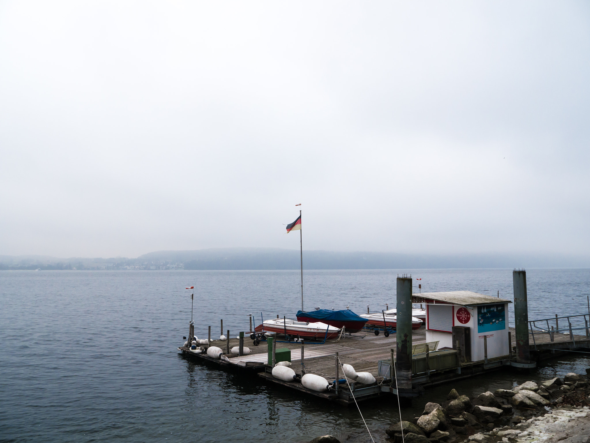 Panasonic Lumix DMC-G6 sample photo. Mooring with wooden planks and white boat fenders photography