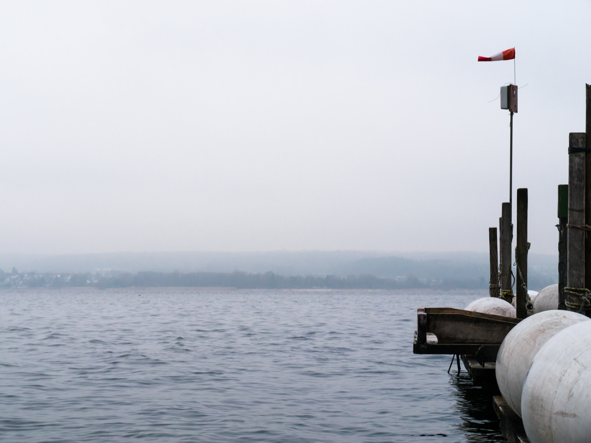 Panasonic Lumix DMC-G6 sample photo. Mooring with wooden planks and white boat fenders photography