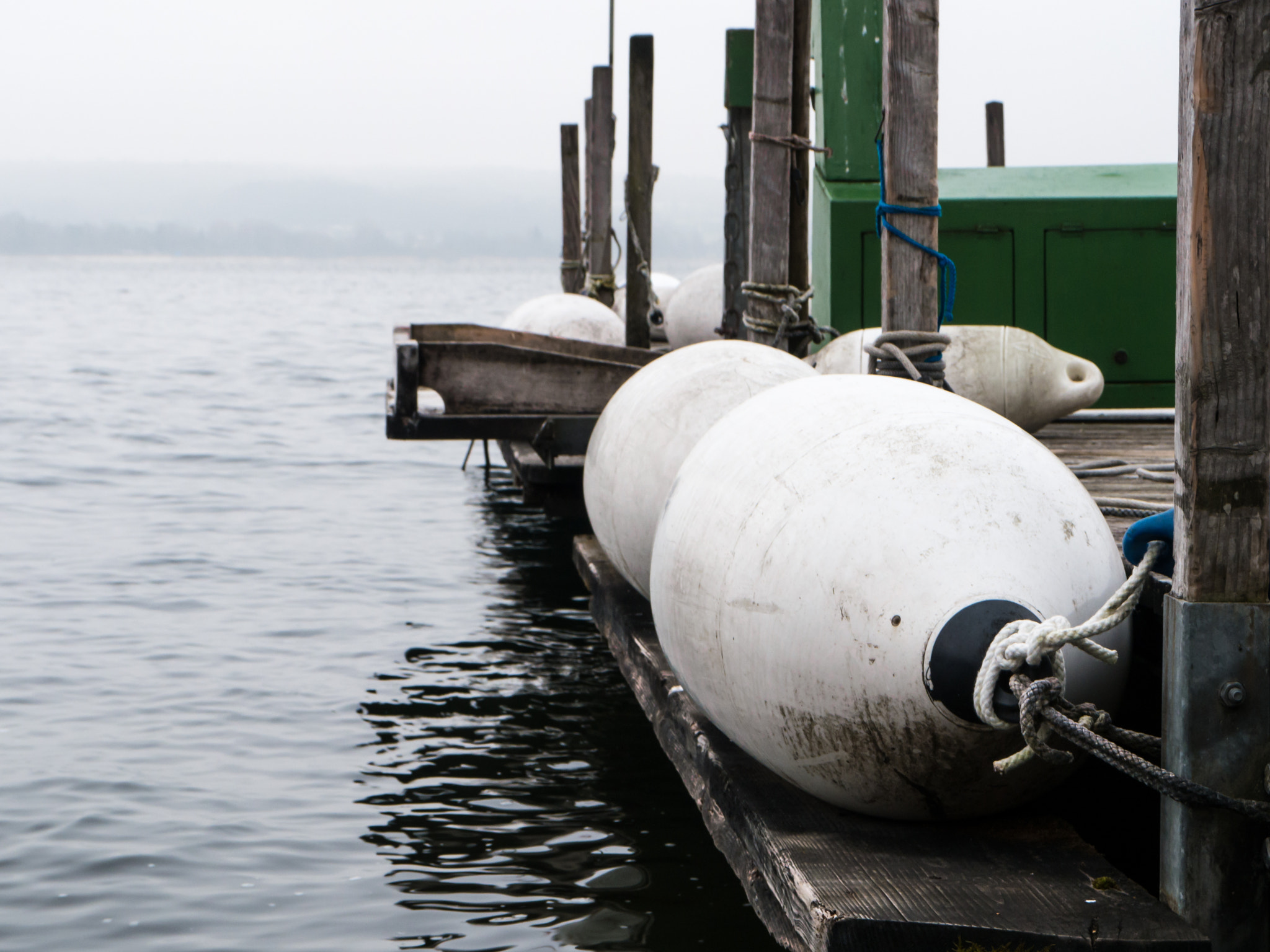 Panasonic Lumix DMC-G6 sample photo. Mooring with wooden planks and white boat fenders photography