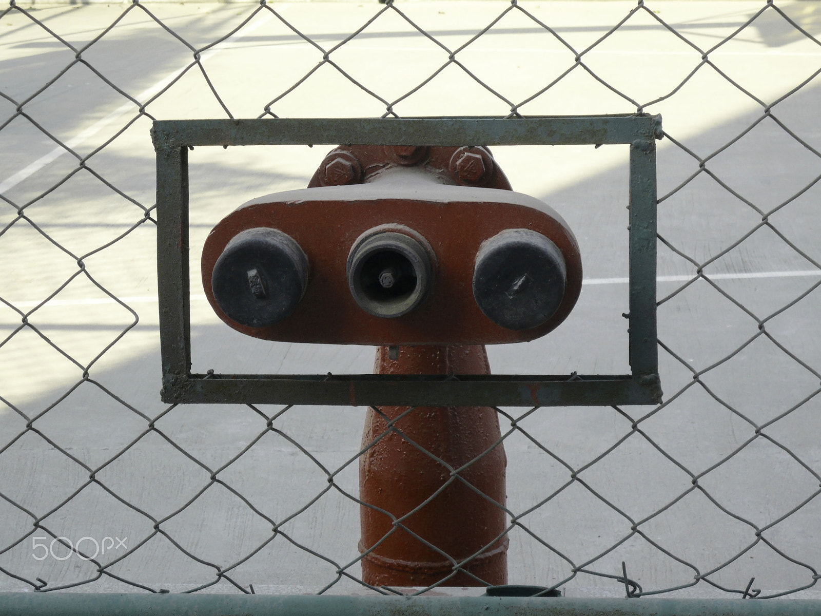 Panasonic DMC-FX100 sample photo. Water hydrants built into a wire mesh fence photography