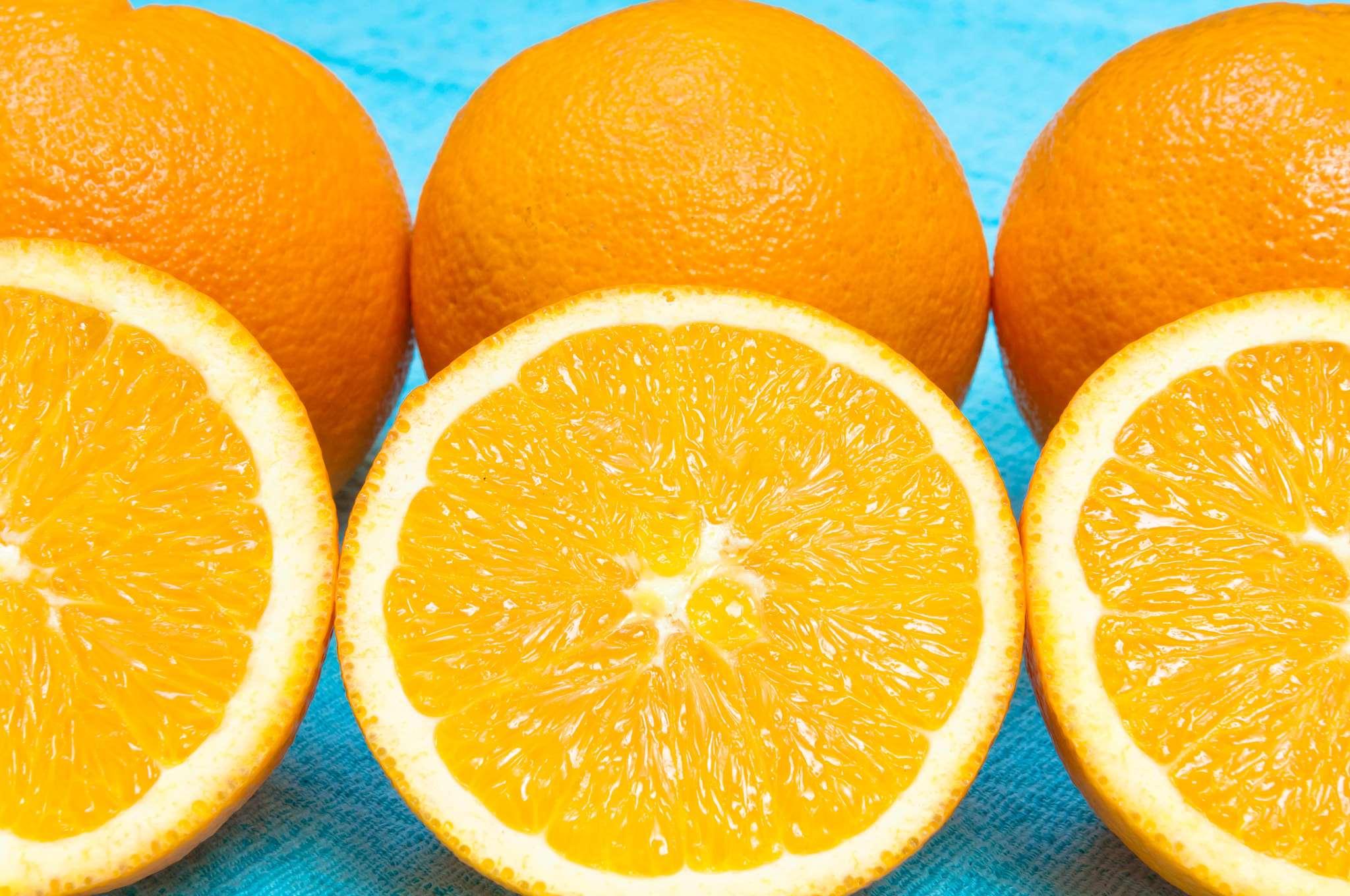 Nikon D2X sample photo. Orange and lemon citrus fruit pattern on light blue background photography