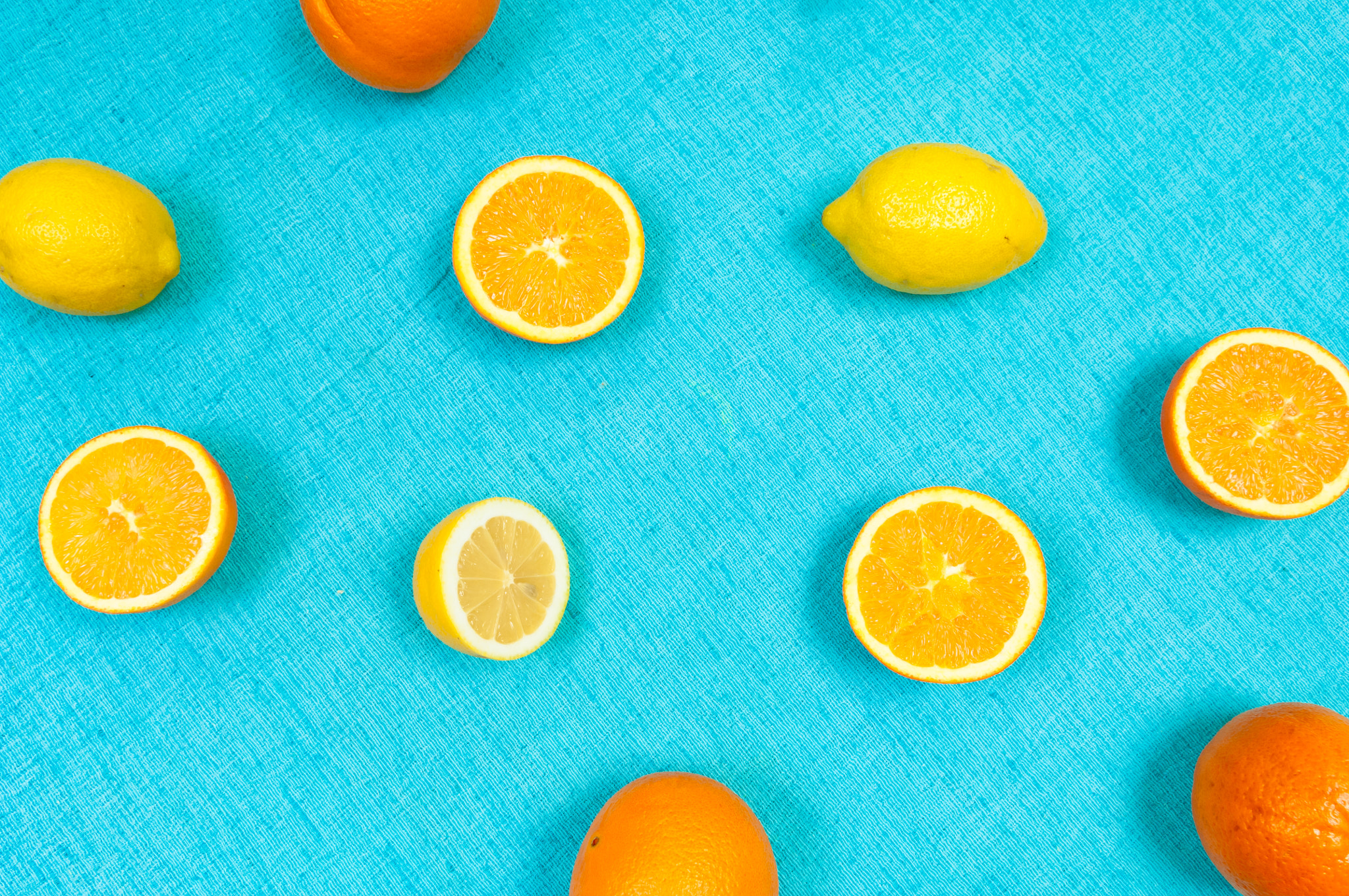 Nikon D2X sample photo. Orange and lemon citrus fruit pattern on light blue background photography