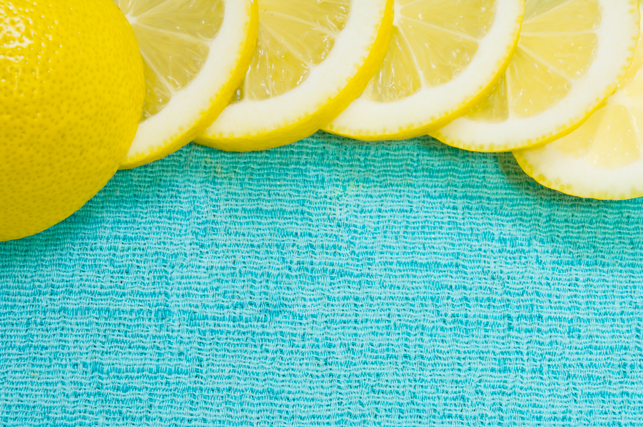 Nikon D2X sample photo. Orange and lemon citrus fruit pattern on light blue background photography