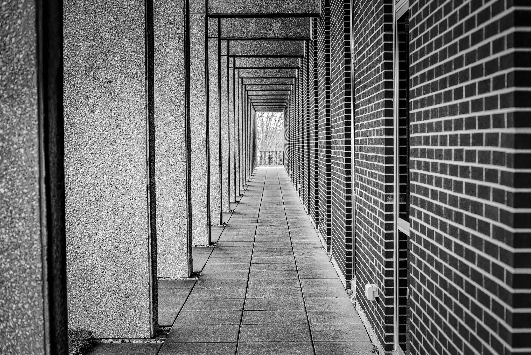 Nikon Df sample photo. Lost in brutalist arches photography