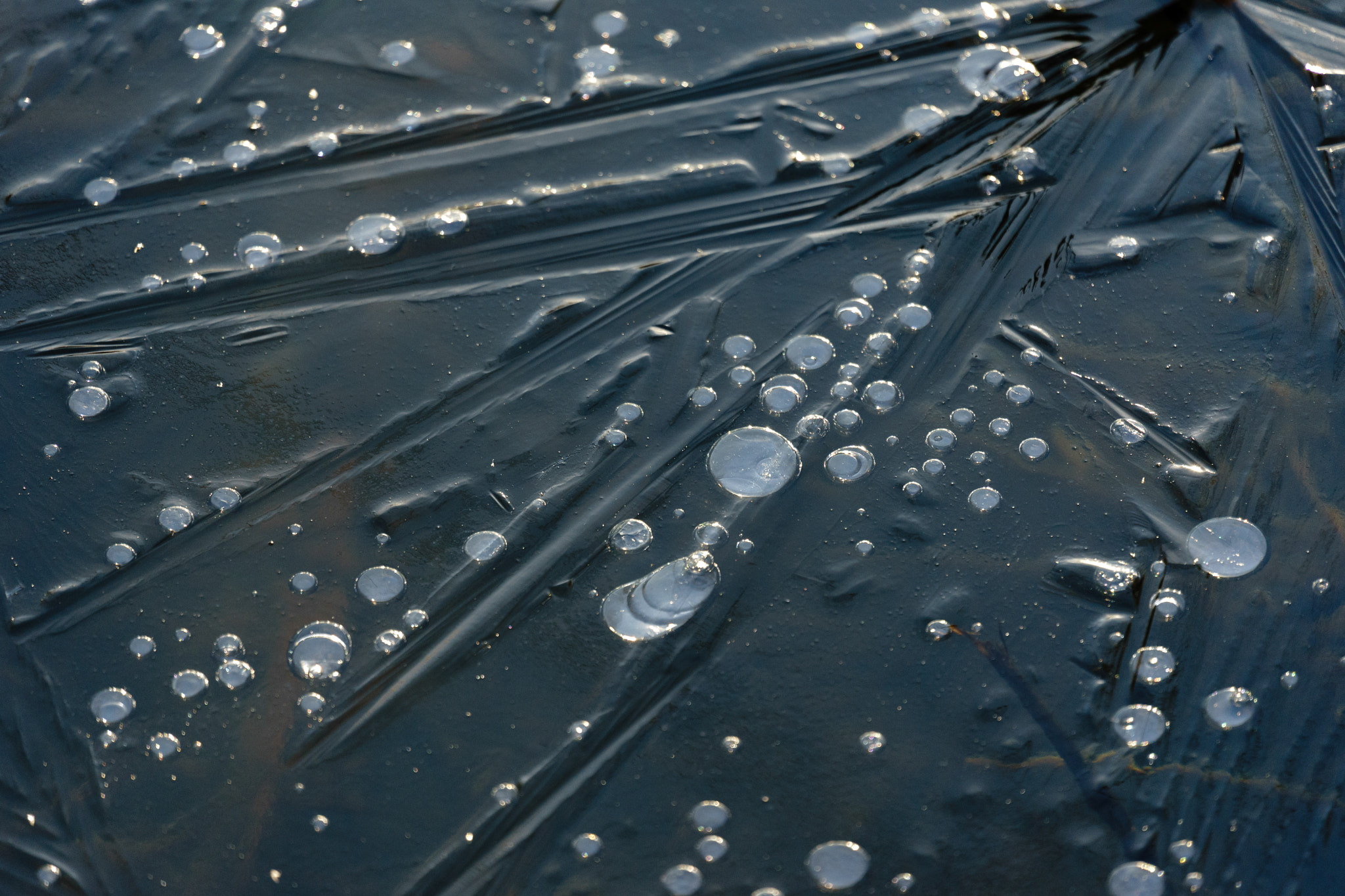 Sony FE 70-300mm F4.5-5.6 G OSS sample photo. Bubbles frozen in an iced over lake photography