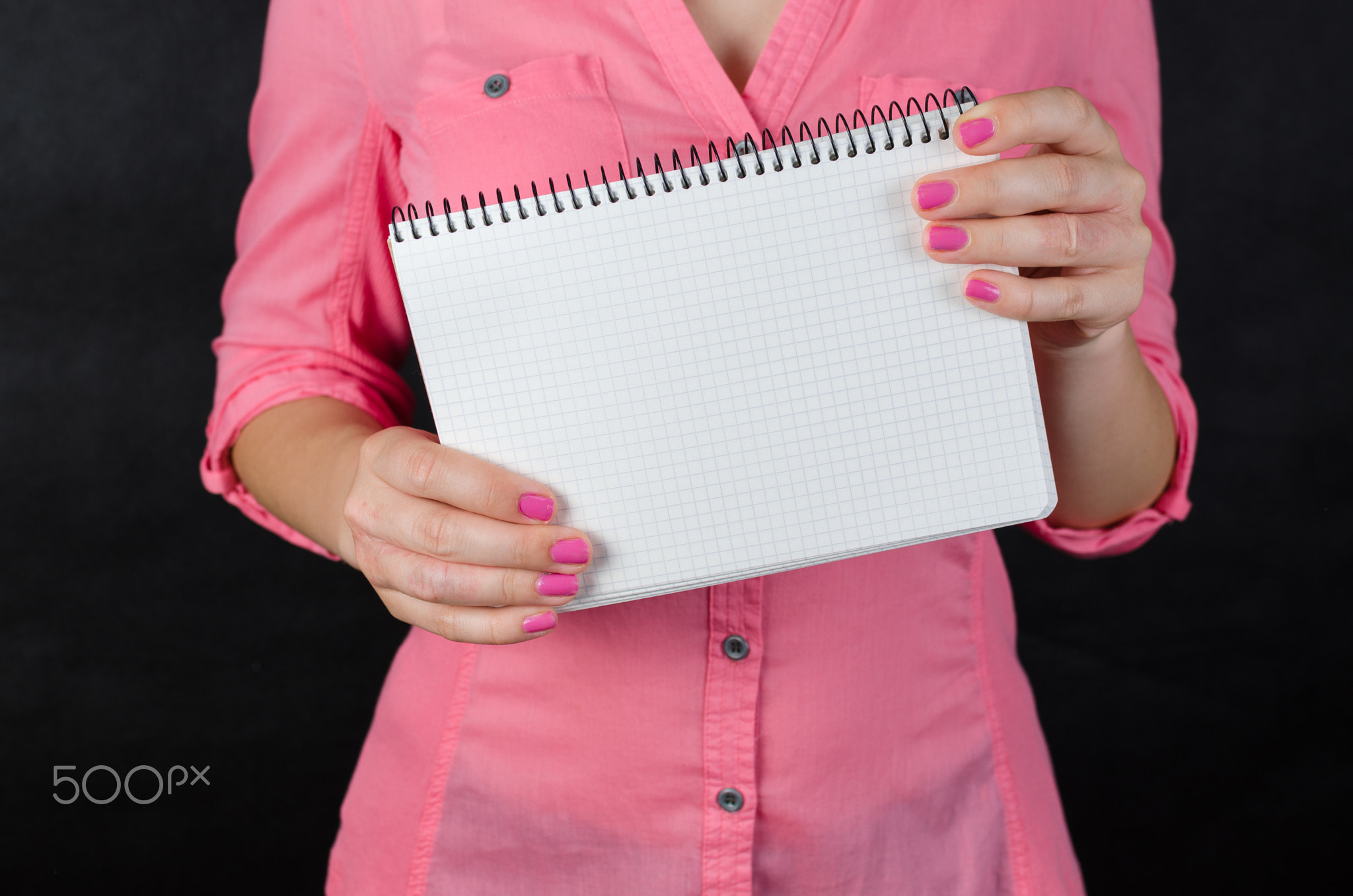 Young woman in pink shirt working