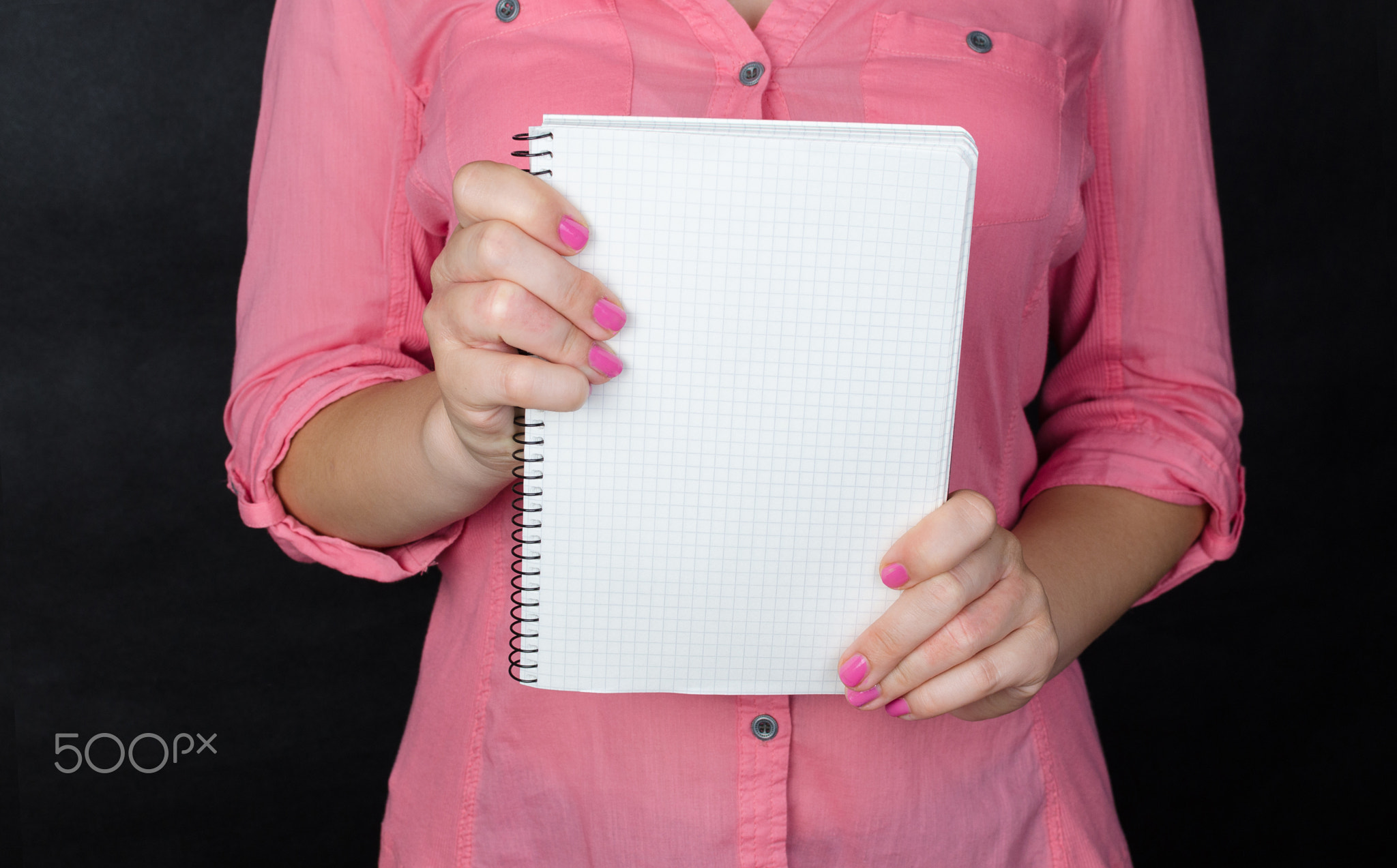 Young woman in pink shirt working