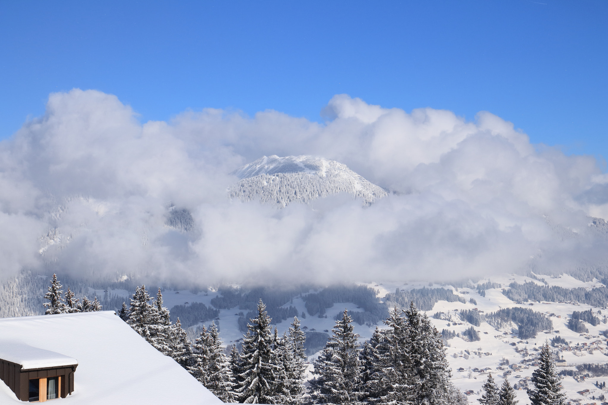 Sigma 17-70mm F2.8-4 DC Macro OS HSM sample photo. Mountain in clouds photography