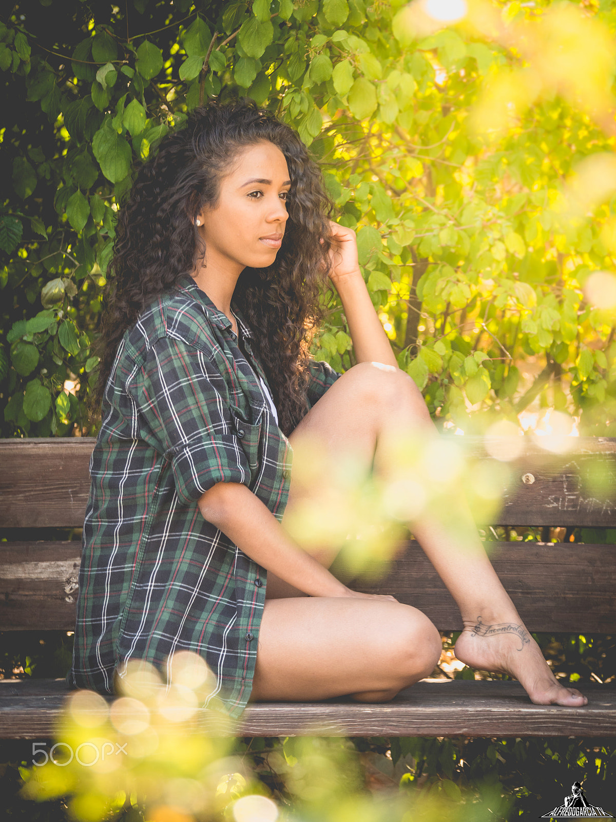 Panasonic Lumix DMC-GH3 sample photo. Hispanic woman sitting on a bench in a park photography