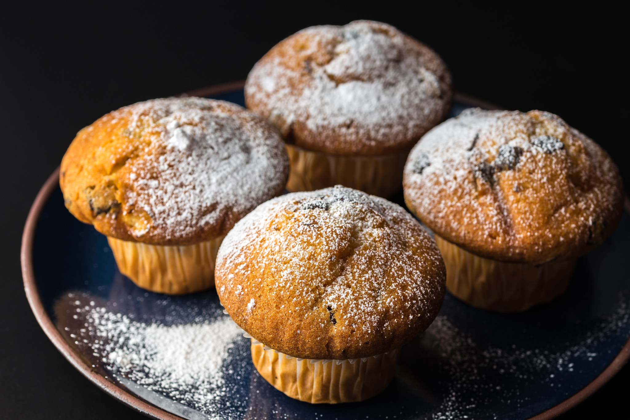 Nikon D610 + Tamron SP 90mm F2.8 Di VC USD 1:1 Macro (F004) sample photo. Chocolate muffins with powdered sugar on dark blue plate. photography