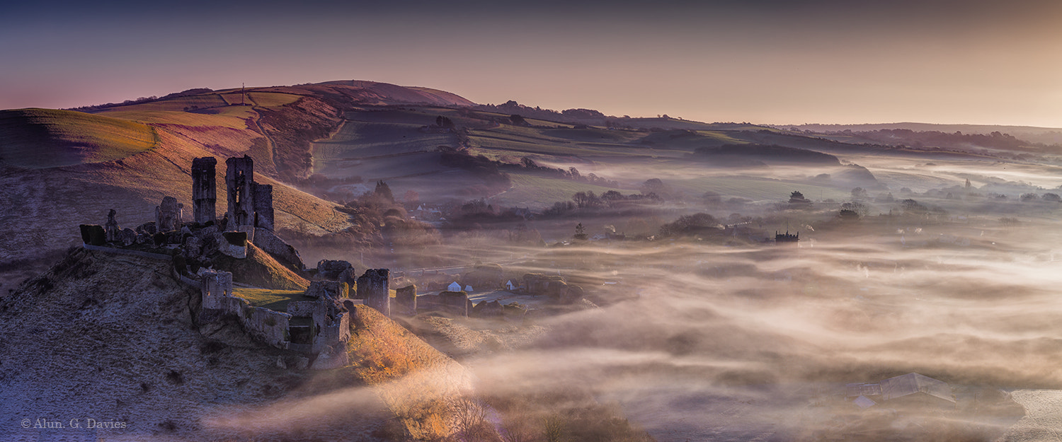 Canon EOS 5DS sample photo. Corfe castle emerges from the mist that still shrouds the village as a new day begins. photography