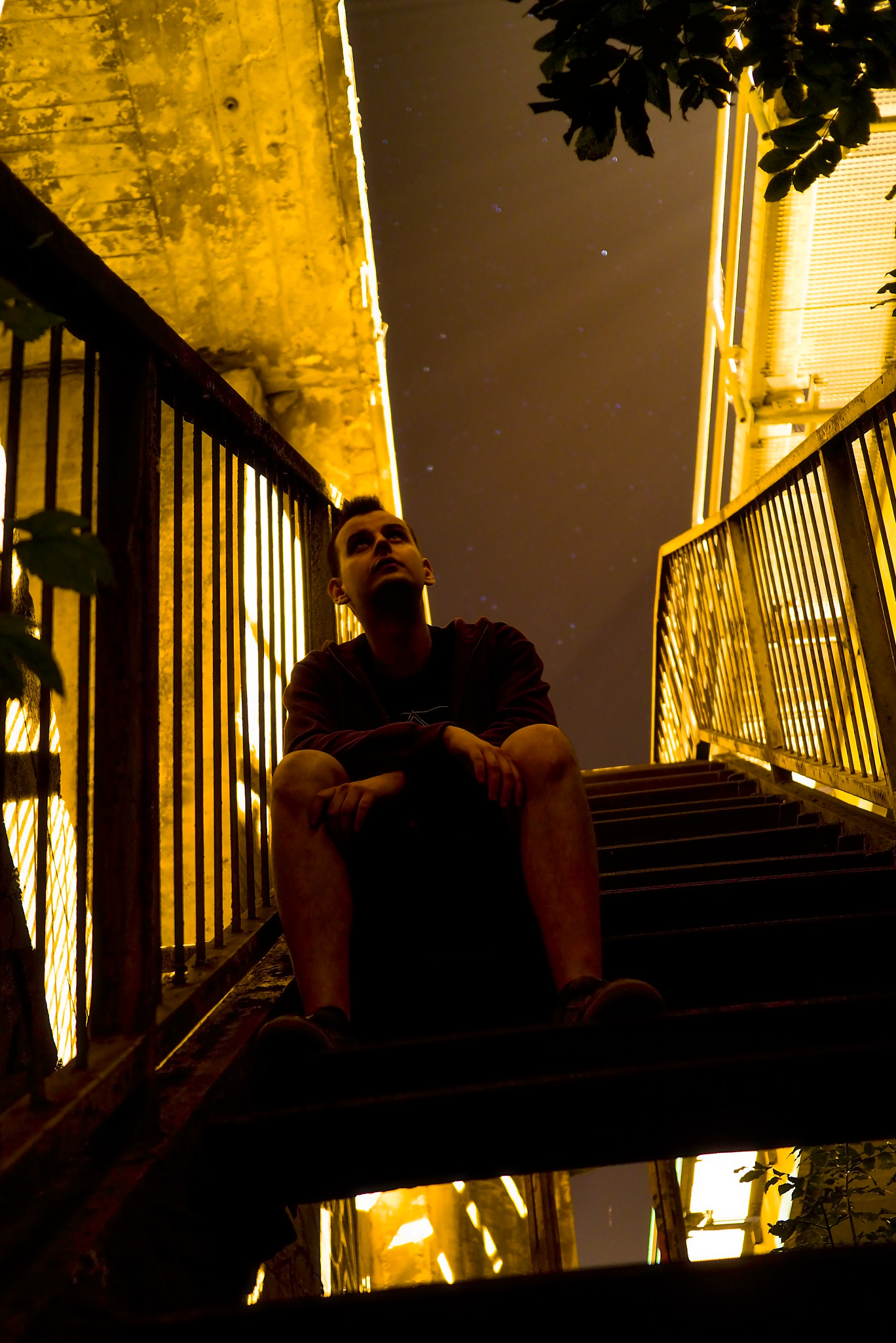 Panasonic Lumix DMC-GX1 sample photo. Man sitting on a stairs looking above photography
