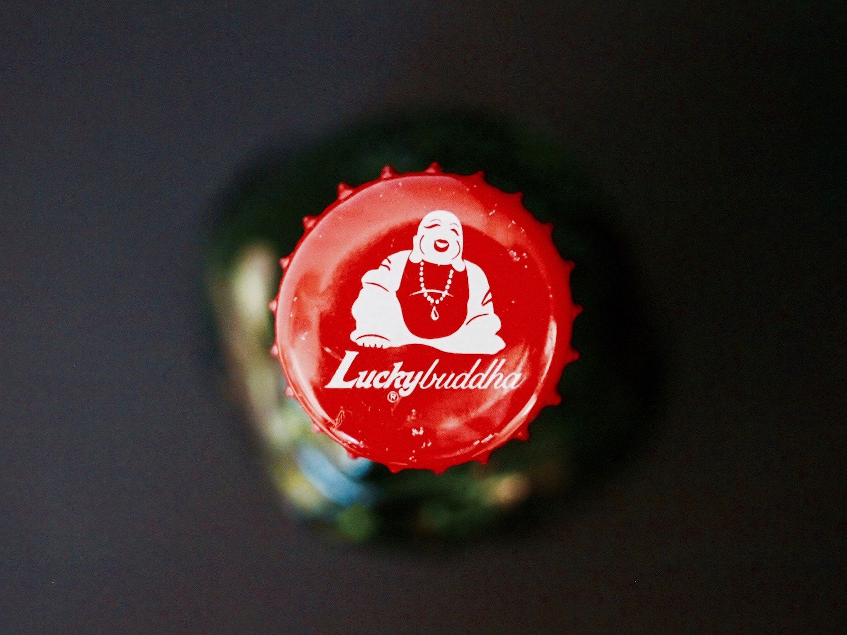 Olympus PEN E-PL1 + Olympus Zuiko Digital 25mm F2.8 Pancake sample photo. Lucky buddha beer bottle cap photography