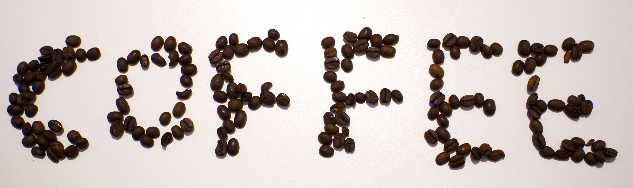 Sony a6000 + Sony E 16mm F2.8 sample photo. Coffee written in beans photography