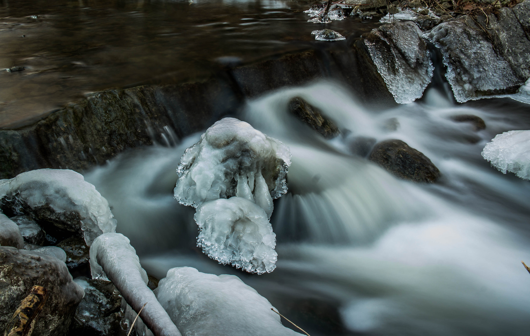 Samsung NX 18-55mm F3.5-5.6 OIS sample photo. Iced rock in creek photography