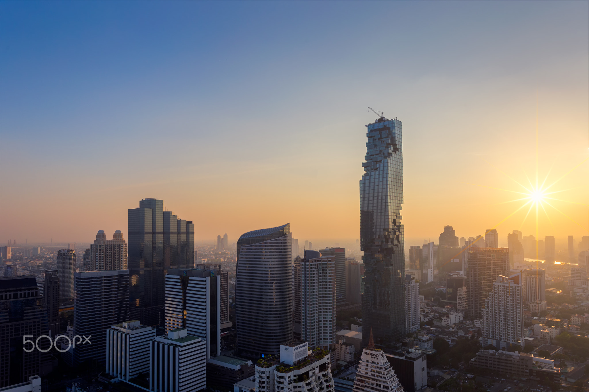 Top view of Bangkok modern office buildings, condominium in Bangkok city downtown with sunset sky...