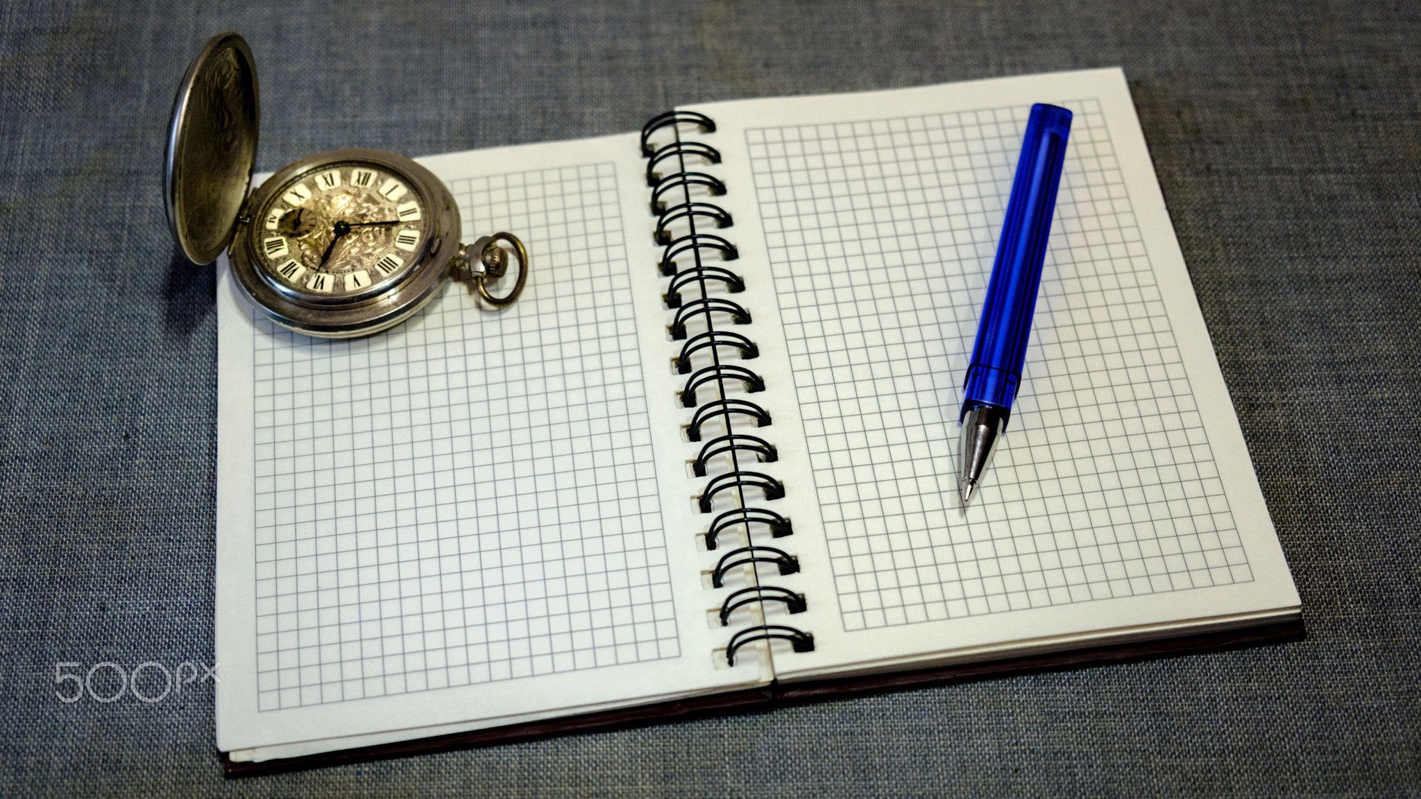 notebook. pocket watch and pen