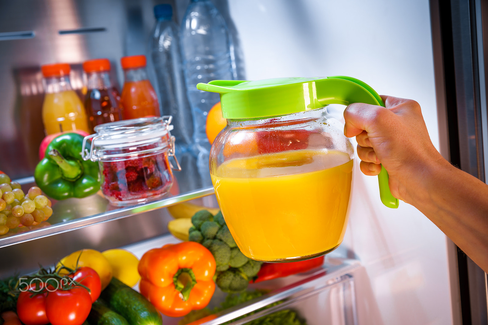 Canon EF 24-70mm F2.8L II USM sample photo. Woman takes the orange juice from the open refrigerator photography