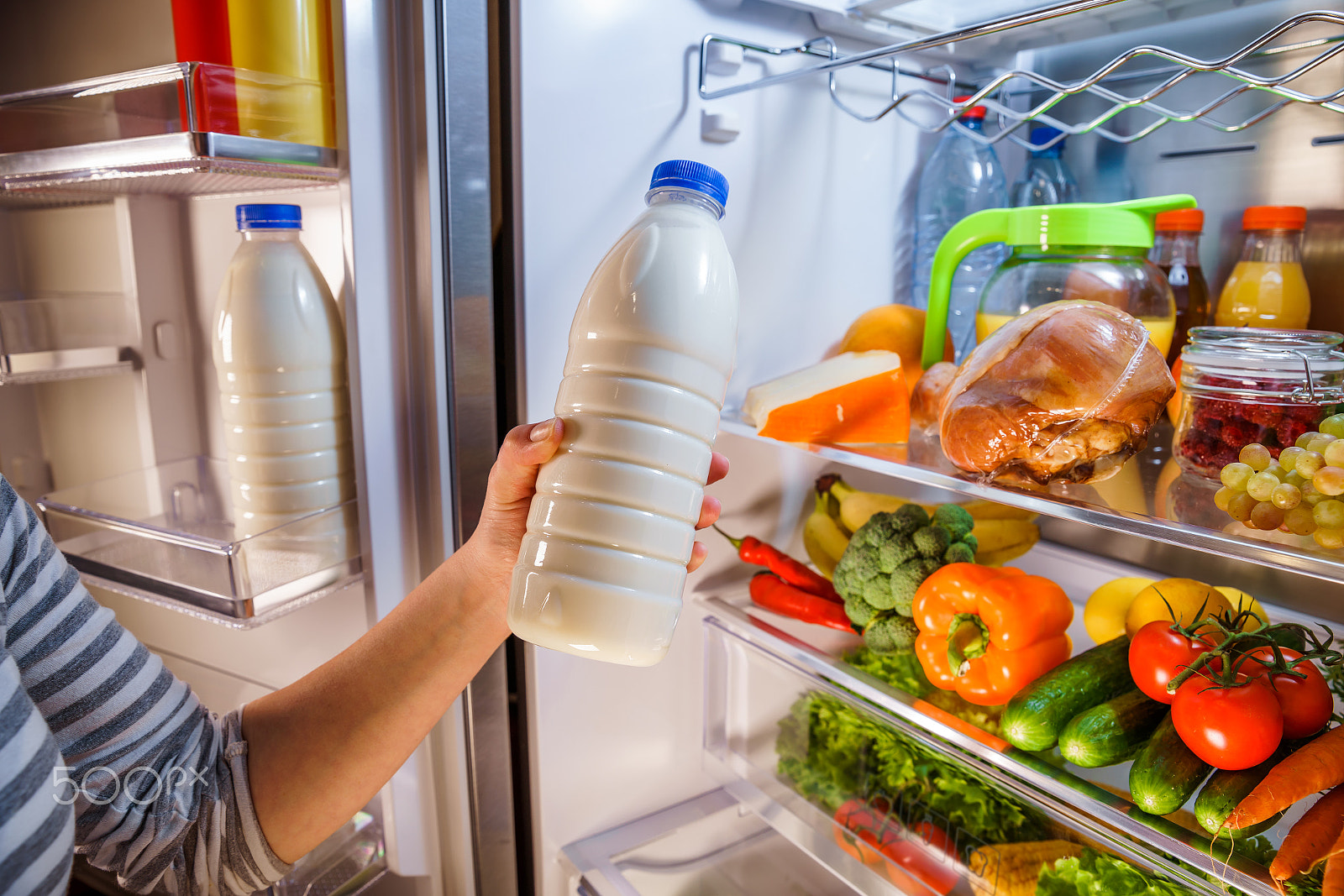 Canon EF 24-70mm F2.8L II USM sample photo. Woman takes the milk from the open refrigerator photography
