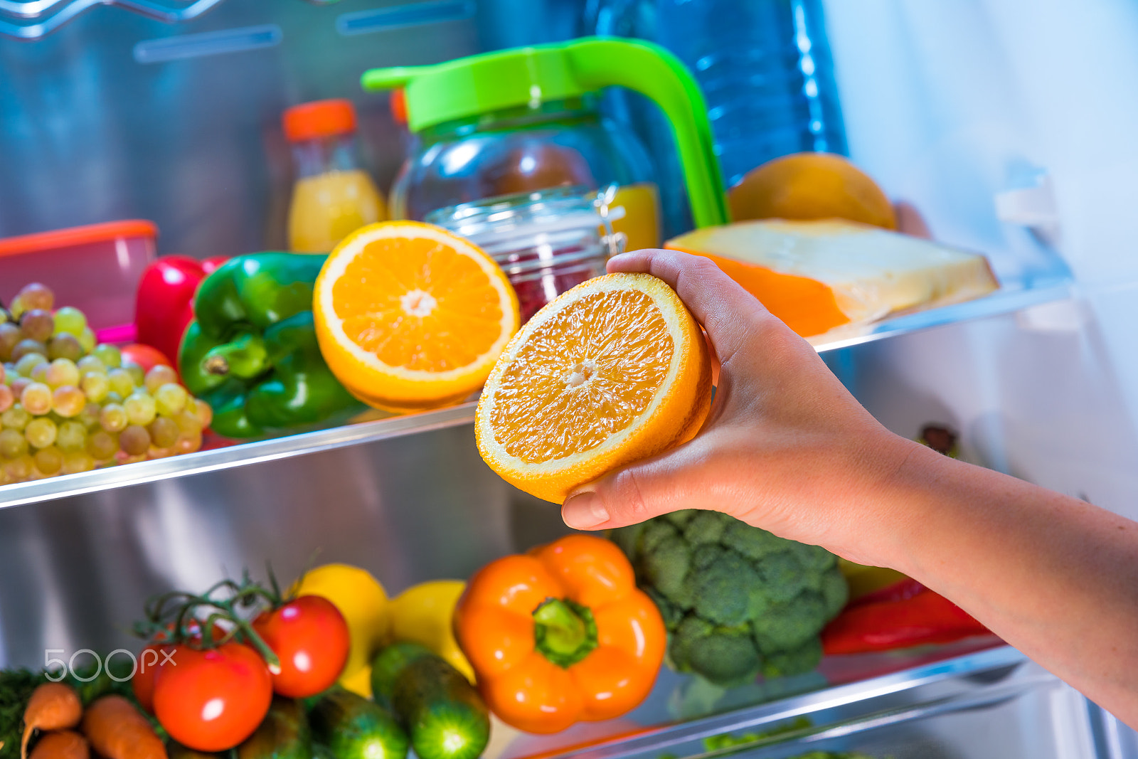 Canon EF 24-70mm F2.8L II USM sample photo. Woman takes the orange from the open refrigerator. photography