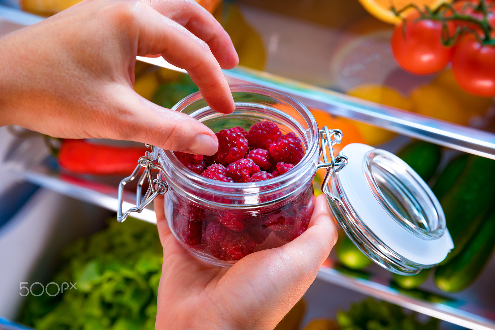 Canon EF 24-70mm F2.8L II USM sample photo. Woman takes the fresh raspberries from the open refrigerator photography