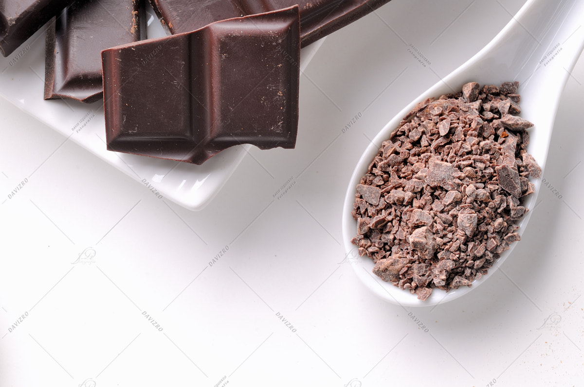 Nikon D300 sample photo. Chocolate chips and portions on white containers close up top photography