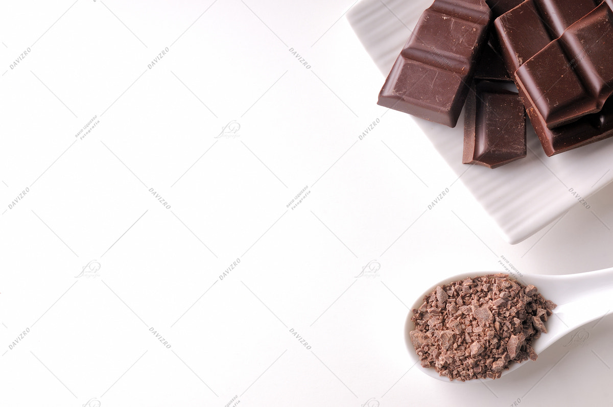 Nikon D300 sample photo. Portions and chocolate chips on white container isolated top photography