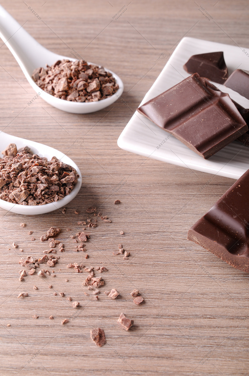 Tamron SP 24-70mm F2.8 Di VC USD sample photo. Portions and chocolate chips on white container on wood vertical photography