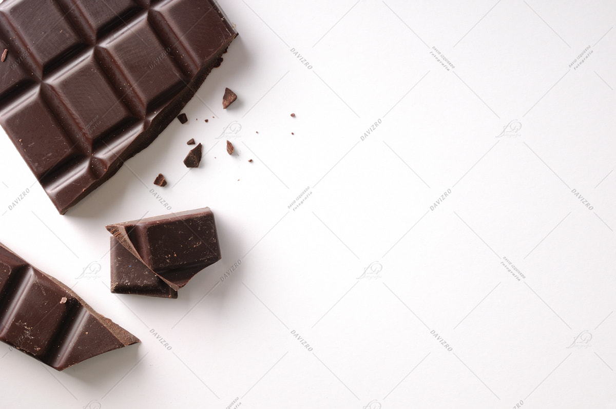 Nikon D300 sample photo. Broken chocolate bar left position isolated top view photography