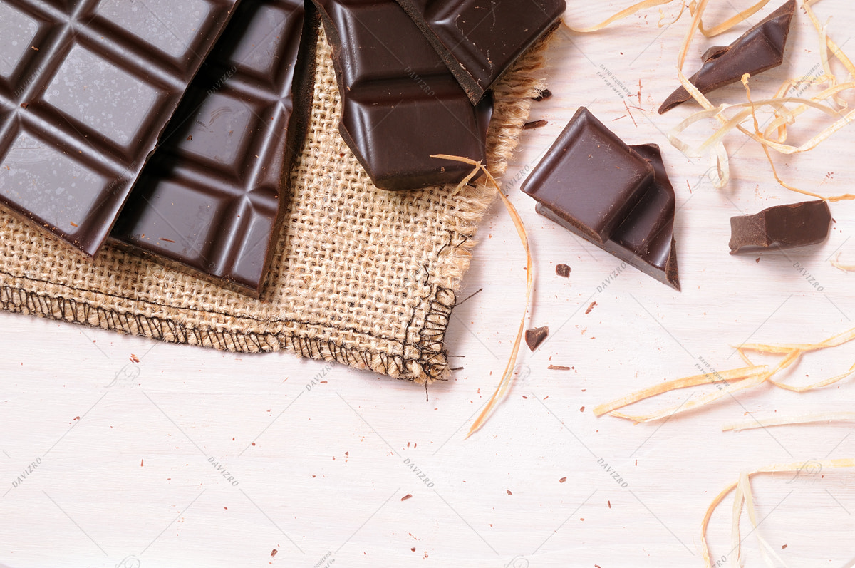 Tamron SP 24-70mm F2.8 Di VC USD sample photo. Broken tablet artisan chocolate on a wooden table top view photography