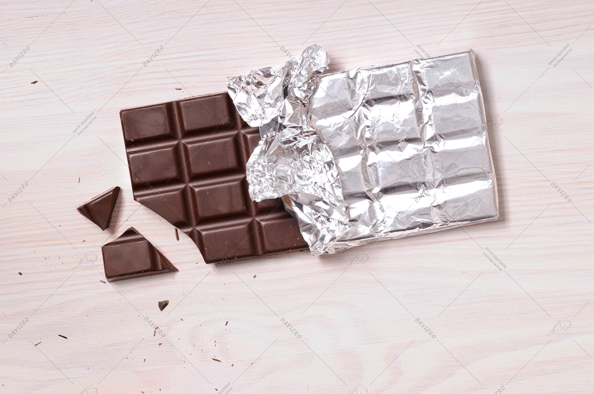 Nikon D300 sample photo. Chocolate bar with silver wrapping top view photography