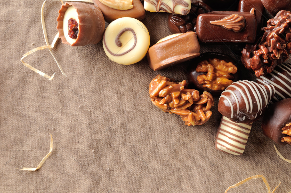 Tamron SP 24-70mm F2.8 Di VC USD sample photo. Group of bonbons stacked on tablecloth fabric with straw decorat photography